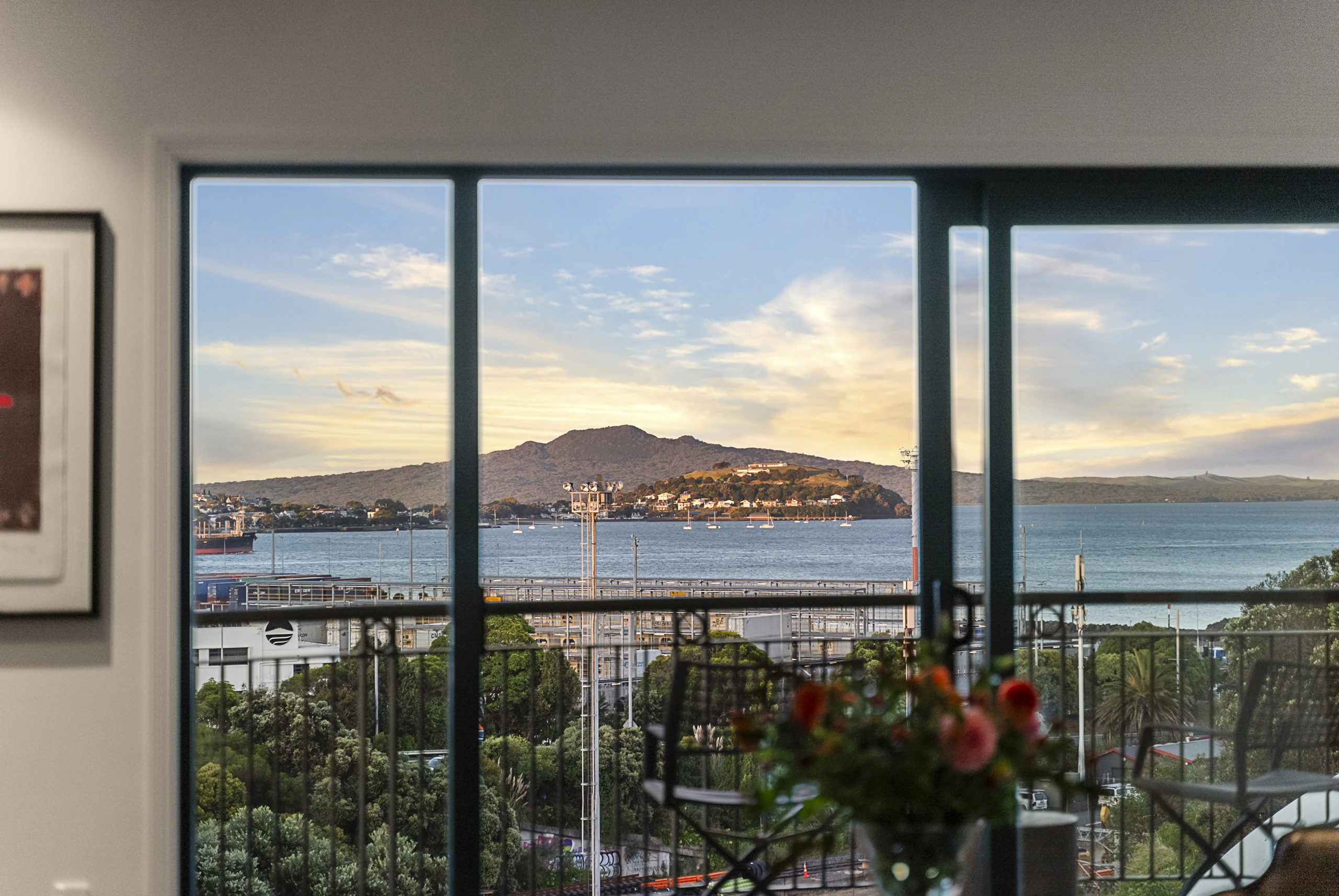 Dining area opening to balcony with Rangitoto and Waitemata Harbour views